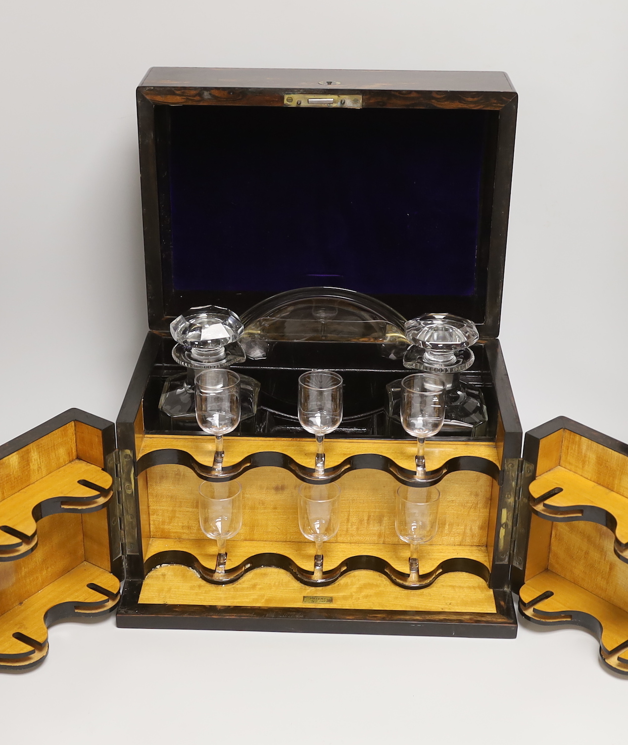 A Victorian coromandel wood two door decanter box, with two decanters and six glasses, 24cm high x 33cm wide